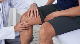 Physician examining an older patient&#039;s knee