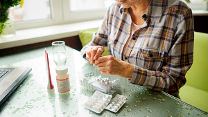 Woman sorting through medications.