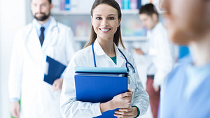 Medical professionals standing holding clipboards