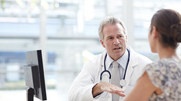 Doctor and patient having a discussion in an office.