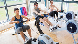 Rowing machines in use at the gym