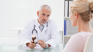 Woman patient discussing rheumatoid arthritis with her doctor.